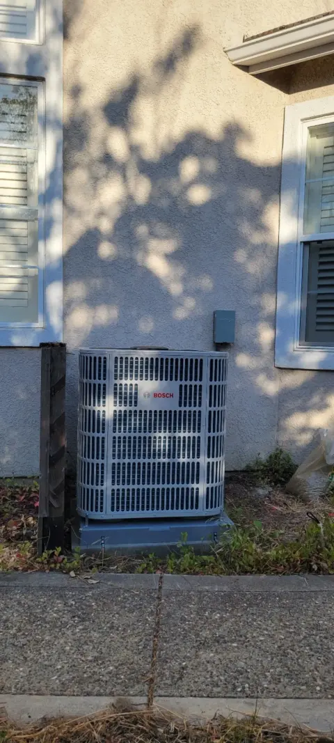 Bosch heat pump outdoor unit installed alongside a Castro Valley home