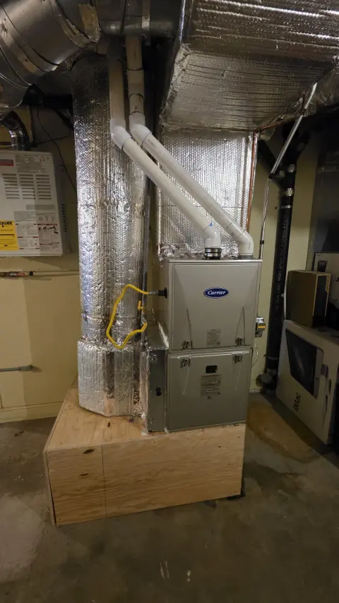 Carrier furnace installation with clean ductwork connections in Clayton