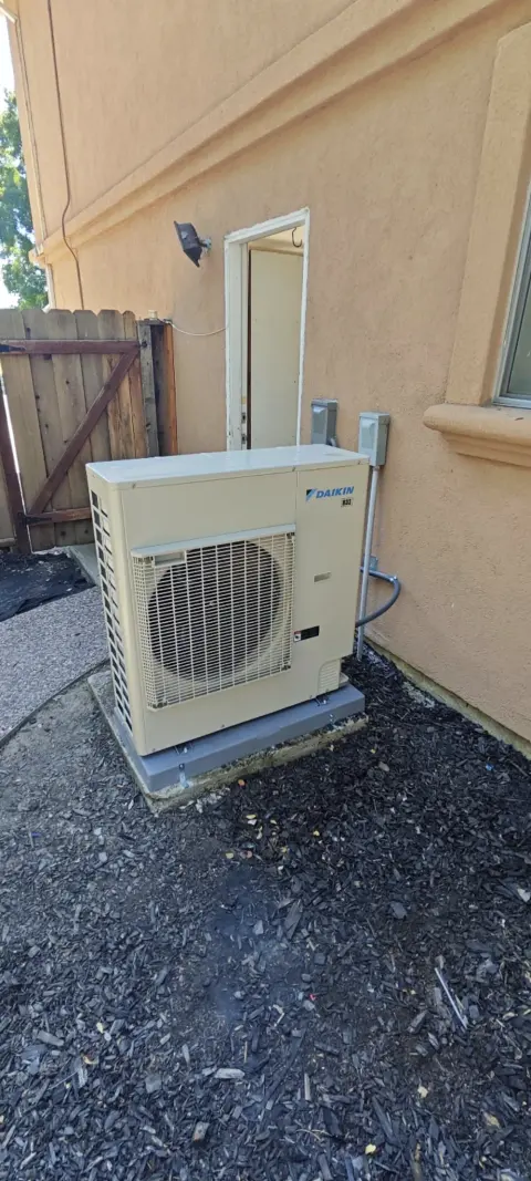 Daikin heat pump outdoor unit installed in a side yard in Livermore