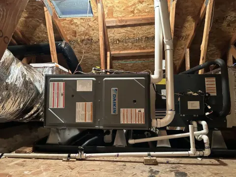 Horizontal furnace in an attic with insulated ducts, vent piping, and a service platform in Fremont