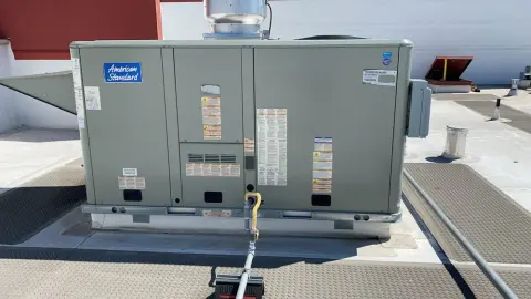 American Standard packaged HVAC unit on a rooftop with service walkways in San Francisco
