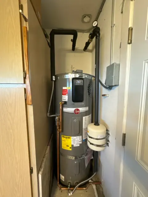 Rheem ProTerra hybrid heat pump water heater installed in a utility closet in Albany