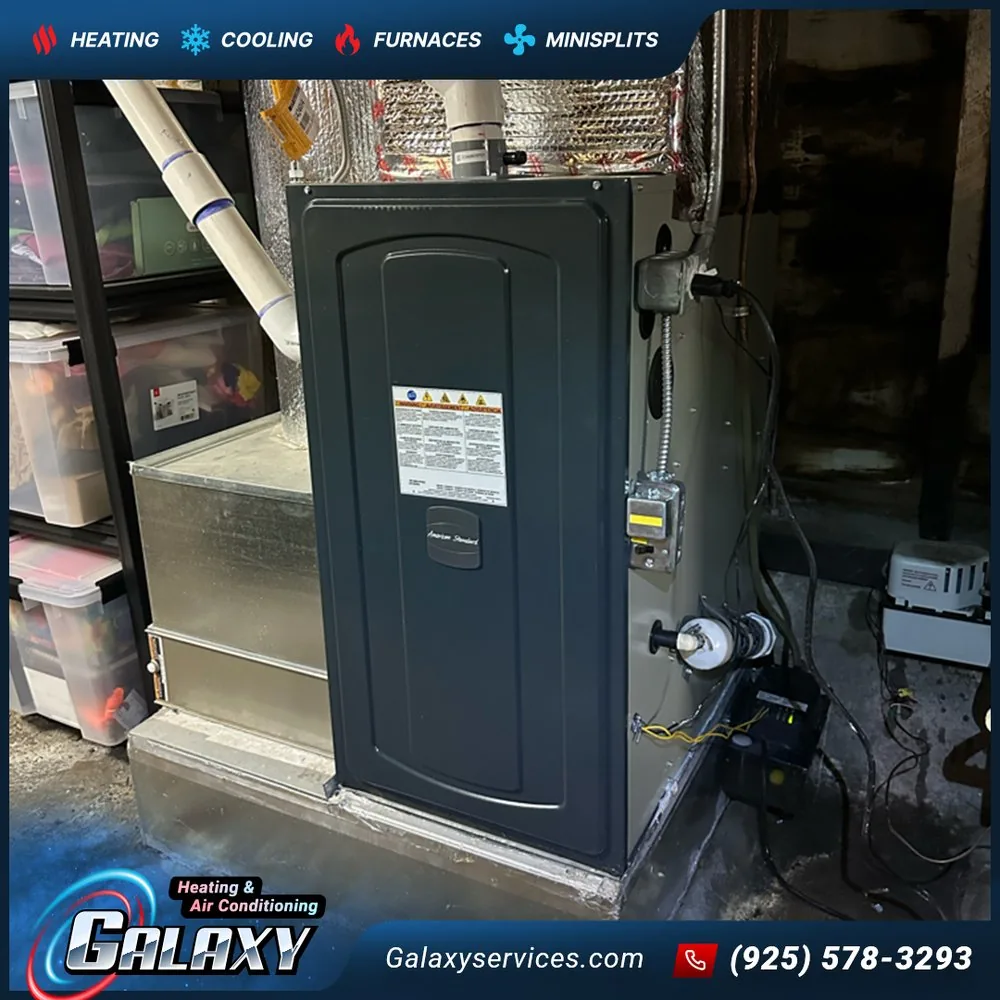 Dark furnace cabinet connected to overhead ductwork in an indoor utility space in Martinez