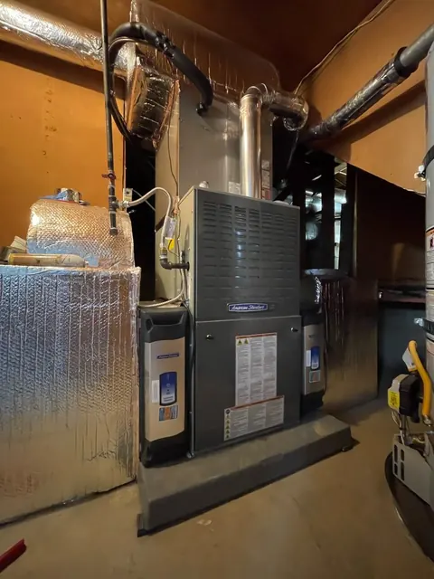 Vertical furnace in a garage with metal venting and insulated ductwork in Danville