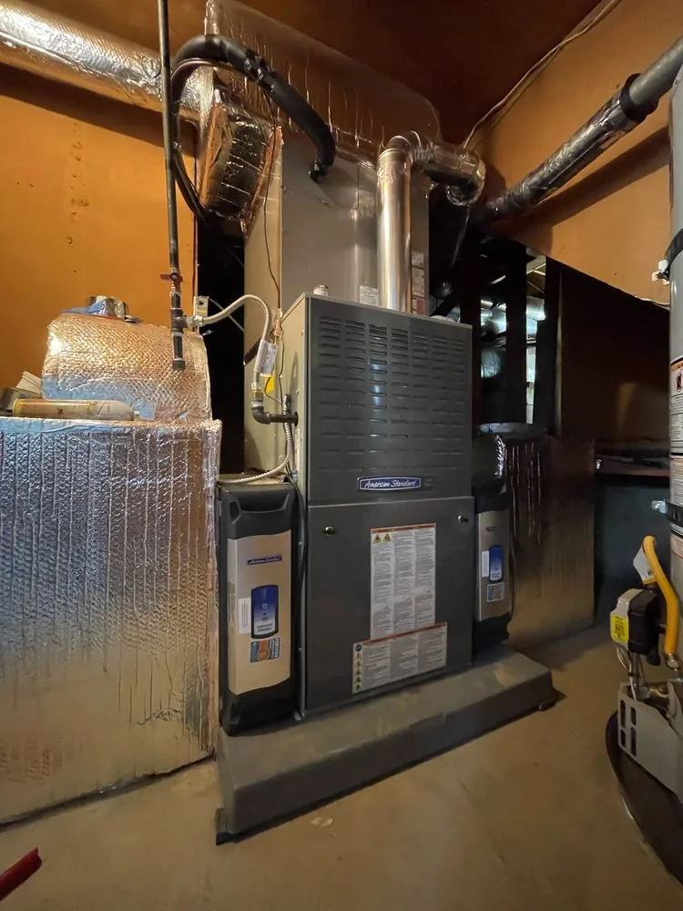 Vertical furnace in a garage with metal venting and insulated ductwork in Danville