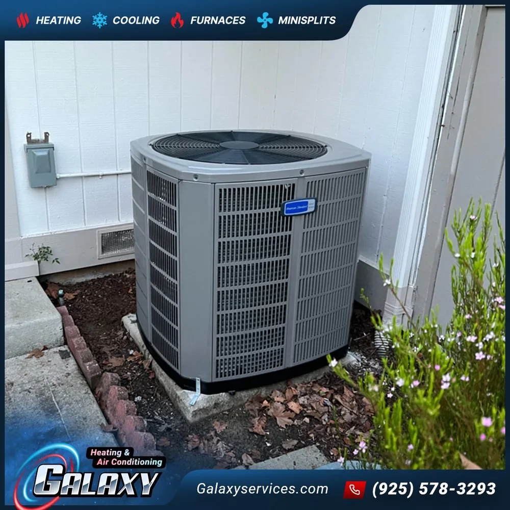 American Standard outdoor air conditioner on a pad beside light-colored siding in Orinda