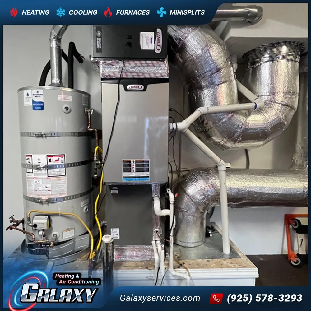 Vertical furnace with foil-wrapped ductwork beside a tank water heater in San Ramon