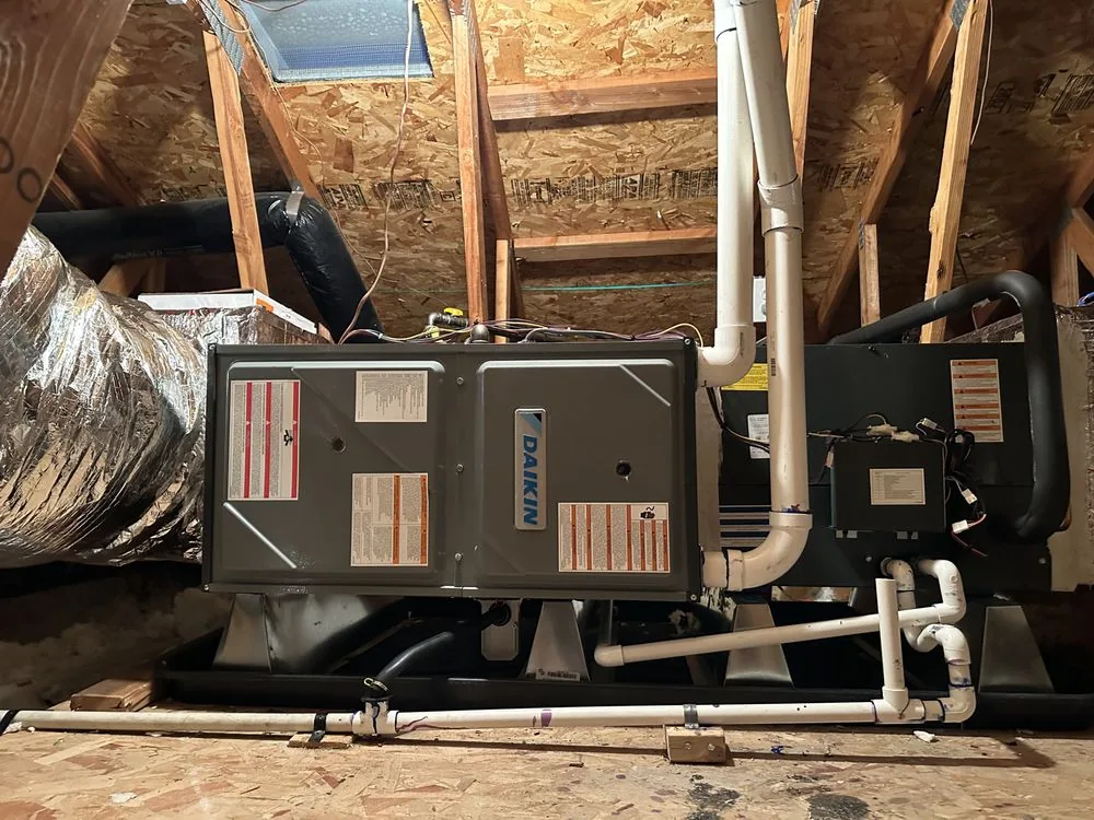 Horizontal furnace in an attic with insulated ducts, vent piping, and a service platform in Fremont
