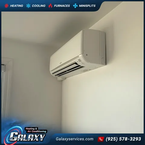 White ductless mini-split indoor unit mounted near the ceiling in a room corner in San Francisco