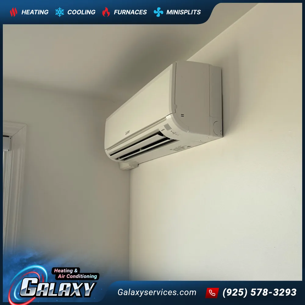 White ductless mini-split indoor unit mounted near the ceiling in a room corner in San Francisco