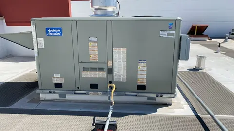 American Standard packaged HVAC unit on a rooftop with service walkways in San Francisco