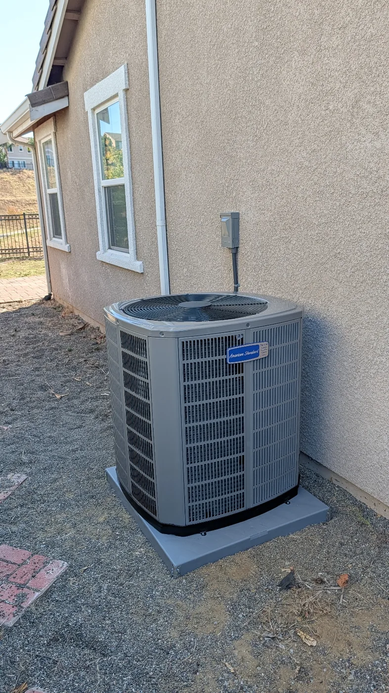 American Standard outdoor heating and cooling unit installed on a level pad at a Brentwood home