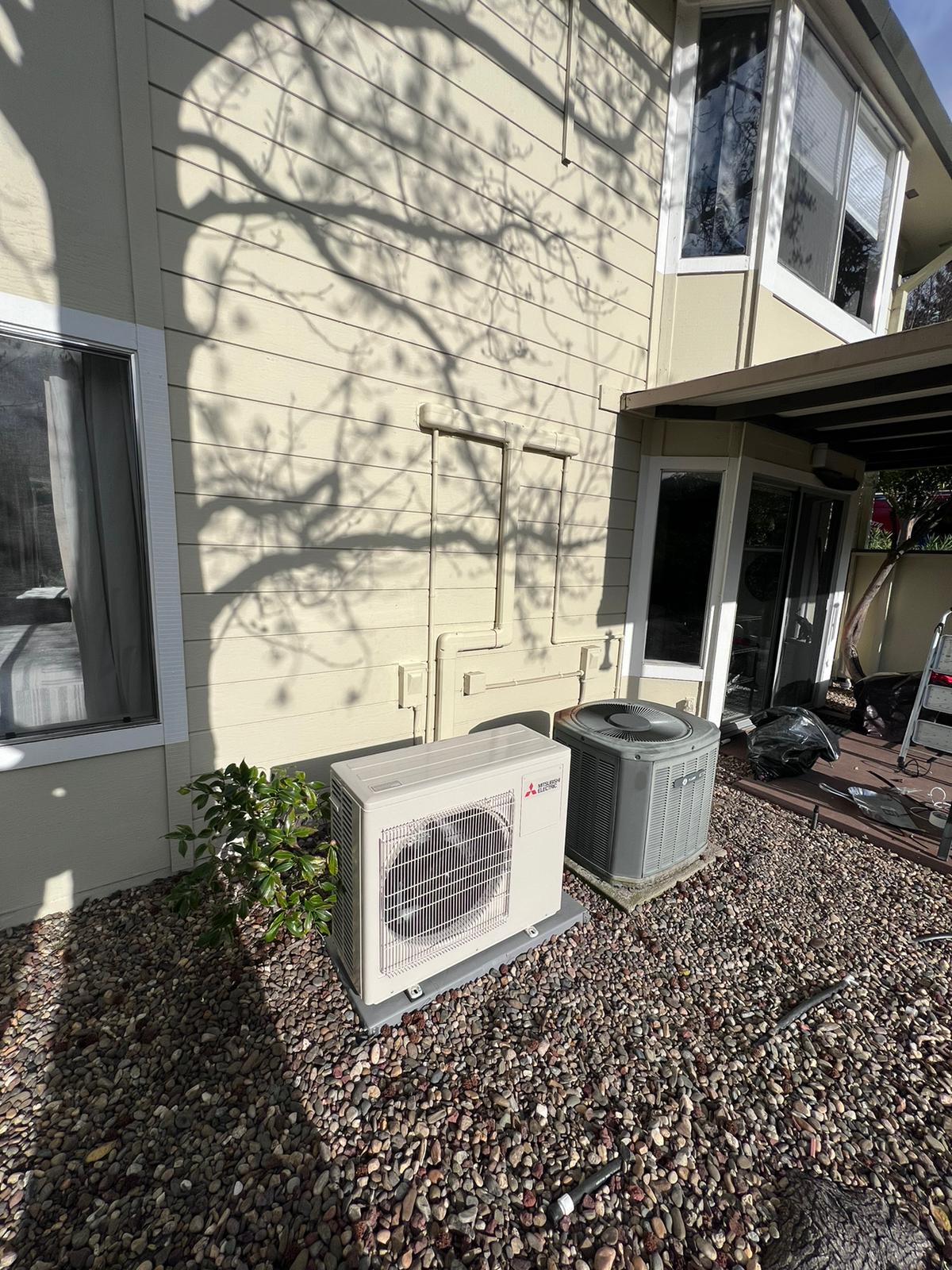 Mitsubishi ductless heat pump outdoor unit installed by Galaxy Heating & Air at an Easton Addition Burlingame home