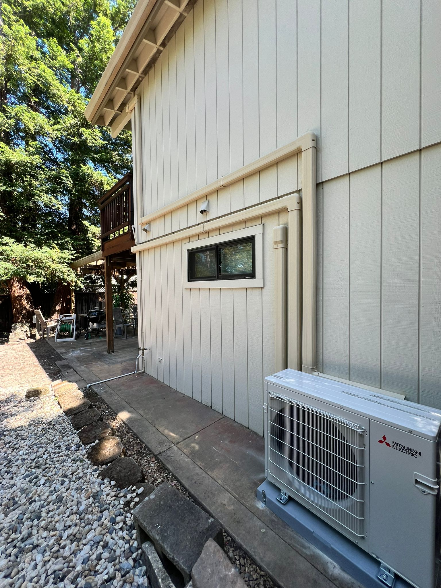 Mitsubishi Electric ductless heat pump outdoor unit installed by Galaxy Heating & Air at a Sleepy Hollow Orinda home nestled among redwoods