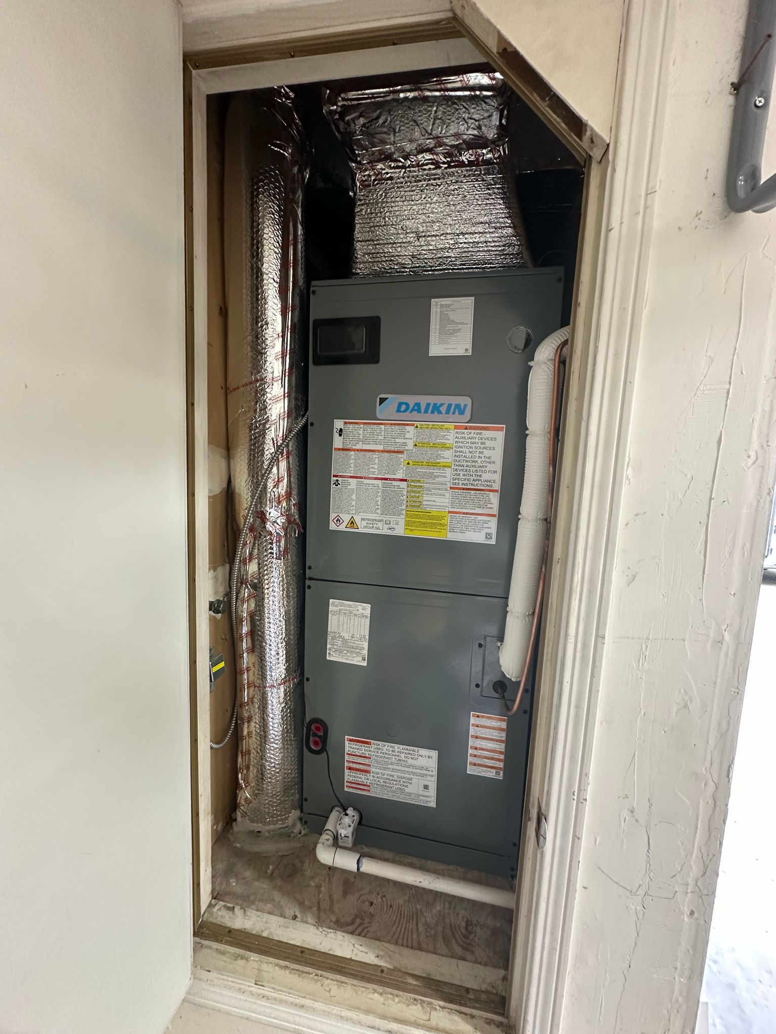 Daikin variable-capacity air handler installed by Galaxy Heating & Air in a utility closet at a Piedmont home