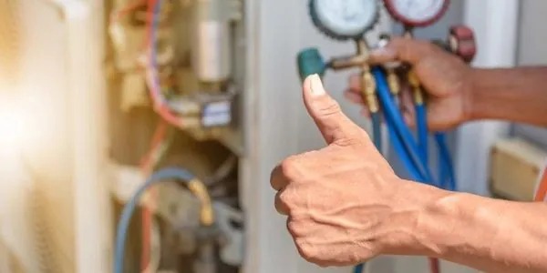 technician from galaxy heating & air conditioning performing maintenance on a heating system.